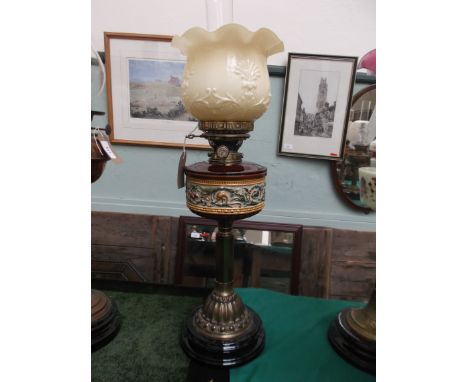 Circular black pot based Royal Doulton table lamp with corinthian brass column to the multi-coloured brown based bowl in trad