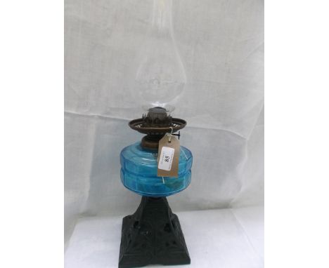 Metal based table lamp with light blue bowl and shaped chimney