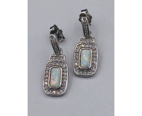 A pair of silver CZ and opal drop earrings