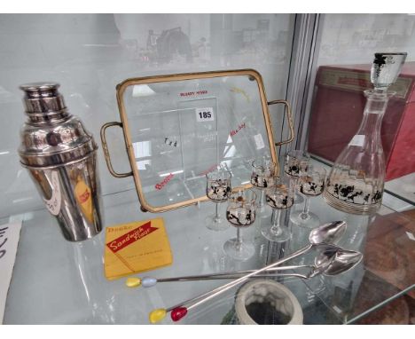 A cocktail shaker, decanter, six glasses, tray  and four spoonsA few light nibbles on various glasses and decanter. Generally