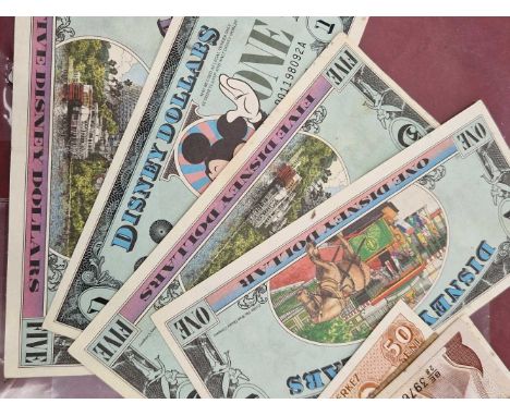 Four vintage Disney Dollar banknotes and various other world banknotes.