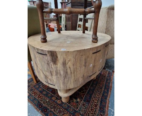 A very large tree trunk chopping block.