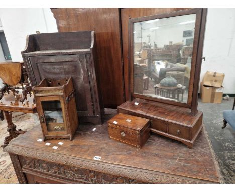 A Georgian swing mirror, a smokers cabinet, a tea caddy, and a rustic wall cabinet.