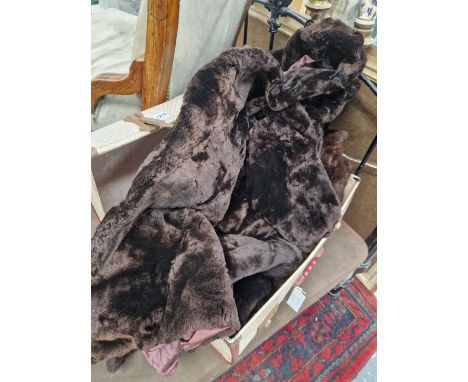 Vintage fur coat and a jacket in a suitcase. 