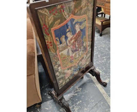 A Victorian fire screen with glazed tapestry panels.