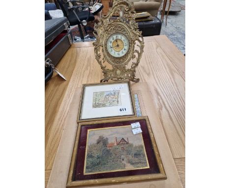 An antique cast brass cased easel back mantle clock together with two small watercolour and a print.