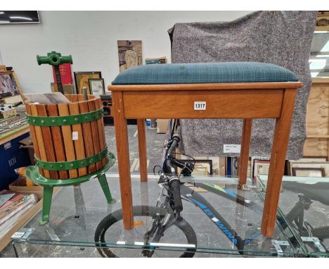 A VINTAGE GRAPE PRESS AND A PIANO STOOL