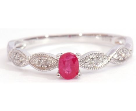 Modern ruby and diamond set ring centring an oval faceted ruby, raised between small diamond set plaited shoulders, stamped 7