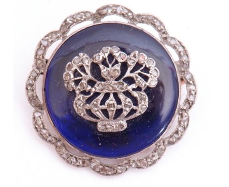 Victorian diamond and blue enamel brooch, the circular blue enamel panel applied with a diamond set bar and flower design, th