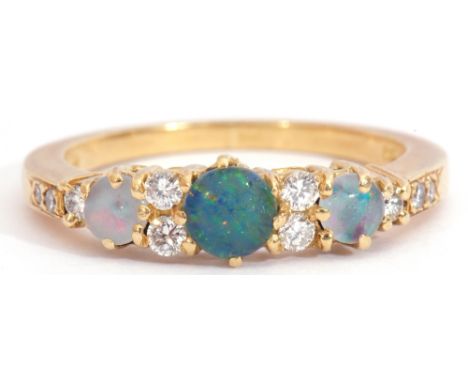 18ct gold, opal and diamond ring, featuring three graduated round cut opals, interspersed by ten small graduated diamonds, si