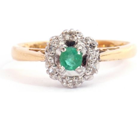 Modern 18ct gold emerald and diamond cluster ring, the round cut emerald four claw set and raised within a surround of 6 smal