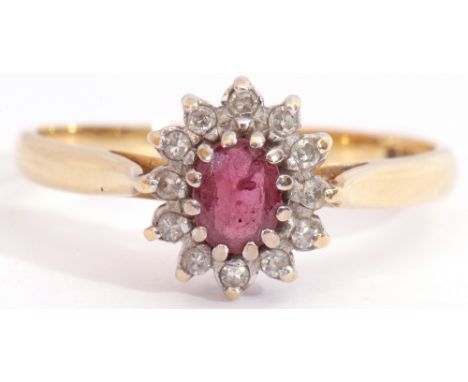 Ruby and diamond cluster ring, featuring an oval faceted small ruby, multi-claw set and raised within a small diamond surroun