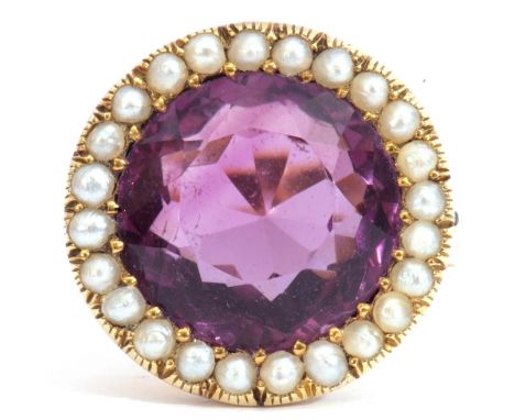 Large amethyst and seed pearl dress ring, the round cut amethyst, 14mm diam, set within a surround of small seed pearls raise