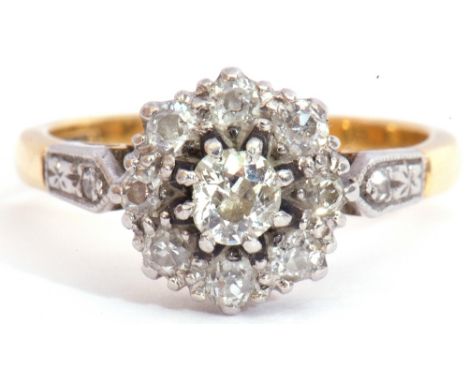 Diamond cluster ring centring an oval cut diamond of 0.20ct approx, raised within a diamond set surround and shoulders, stamp