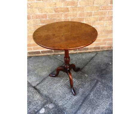 AN OAK TRIPOD OCCASIONAL TABLE  the circular top 61cm diameter, 72cm high overall