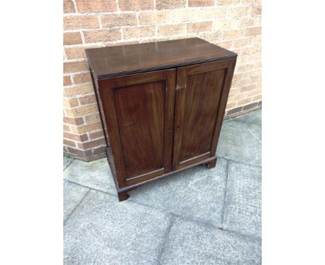 A MAHOGANY SIDE CABINET  the rectangular top with reeded edge above pair of panelled doors on bracket feet, flush fitting bra