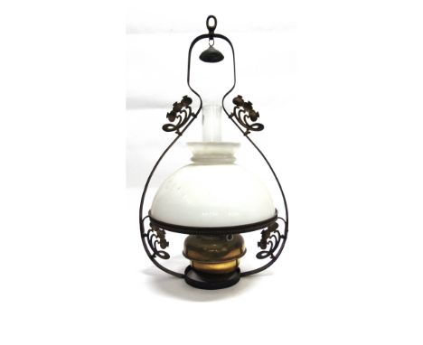 AN EDWARDIAN HANGING OIL LAMP  with brass reservoir, the opaque glass shade 36cm diameter, the metal frame with Art Nouveau d