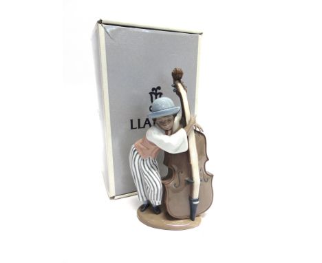 A LLADRO FIGURE 'JAZZ BASS/ CONTRABAJO JAZZ' no. 5834, modelled as a boy playing double bass, 25cm high, (with original box a
