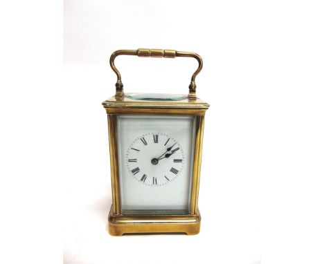 A BRASS CASED CARRIAGE CLOCK  the enamel dial with Roman numerals, 10cm wide 15cm high