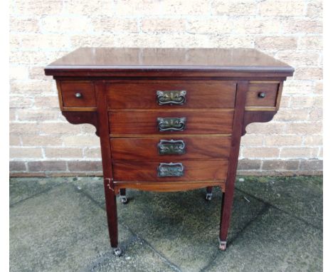 AN EDWARDIAN MAHOGANY CARD TABLE/MUSIC CHEST  the top revolving and opening to a green tooled leather and baize playing surfa