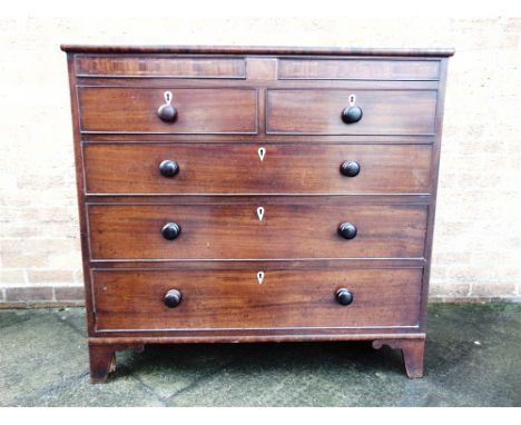AN EARLY 19TH CENTURY MAHOGANY CHEST  with two 'secret' frieze drawers above two short and three long drawers on bracket feet