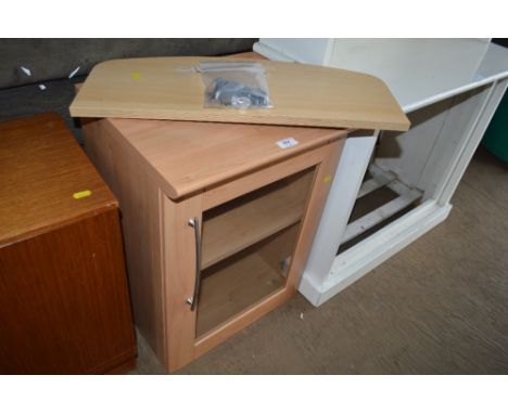 A glass fronted cabinet together with a shelf