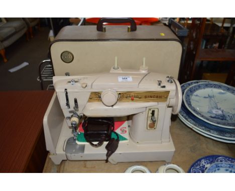 A Singer sewing machine in carrying case sold as collector's item