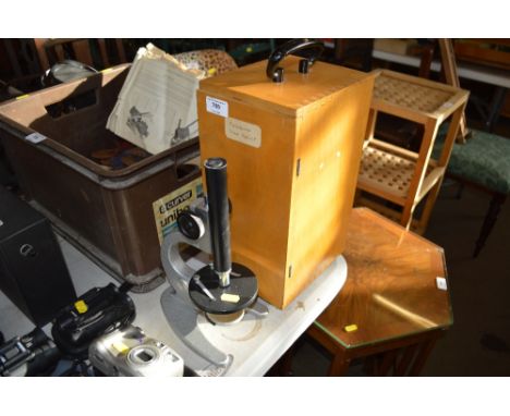 A microscope in fitted case; two cameras; two pairs of binoculars and a camera tripod