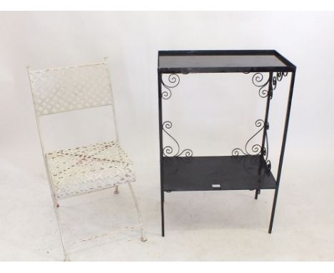 A black wrought iron conservatory shelf and a folding garden chair
