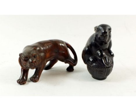 A pair of carved wooden netsuke in the form of a lion and a rabbit, both&nbsp; signed