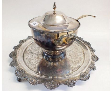 A silver plated circular tray with cast floral border and a silver plated tureen with ladle 
