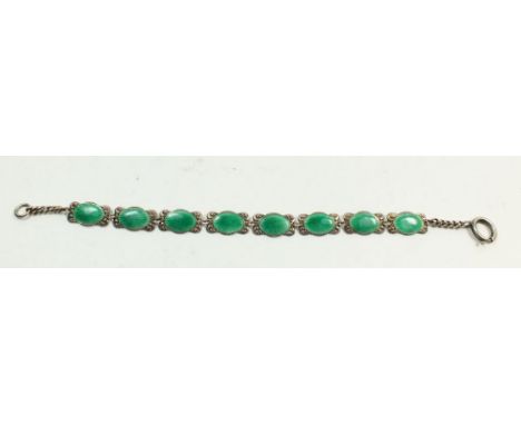 A white metal and green enamel bracelet 