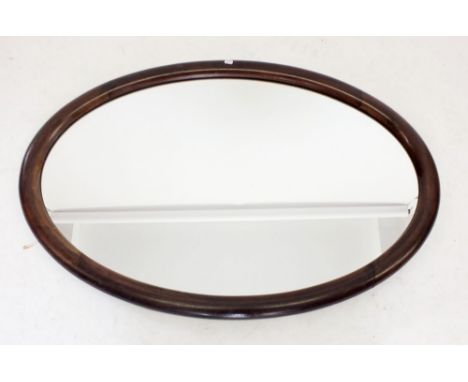 An Edwardian oval mahogany framed mirror 