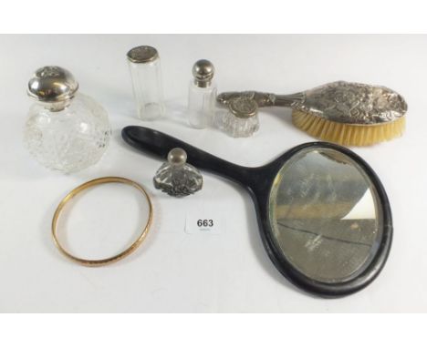 A silver hair brush with embossed angel head decoration and three toiletry/scent bottles with silver tops, hand mirror, gold 