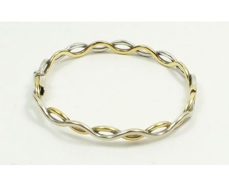 A 9 carat white and yellow gold interwoven bangle, 10g 
