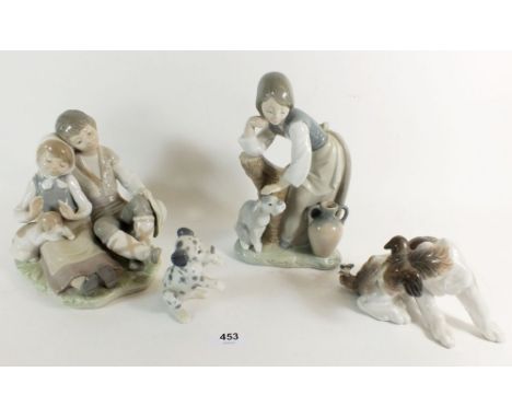 Four Lladro figurines: girl petting a dog, a young boy and girl sat with dog, a dog and butterfly and one other, tallest 20cm