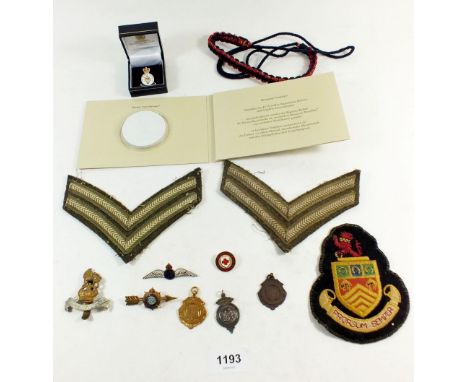 A box of military badges etc. including shoulder badges, cap badge, RAF silver and enamel wings badge, silver sports medal et