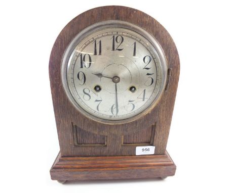 An oak Junghans arch top mantel clock with striking movmeent 