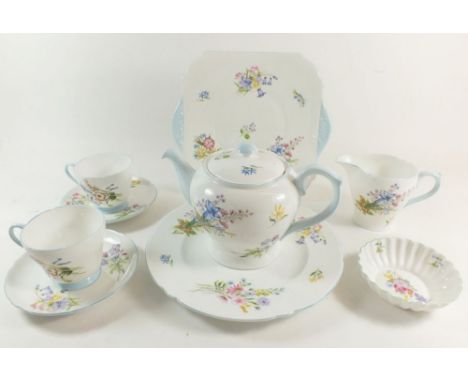 A Shelley Wild Flowers tea service comprising: teapot, milk and sugar, ten cups and eight saucers, six breakfast cups and sau