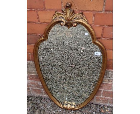 A gilt framed shield form mirror, 91 x 55cm 