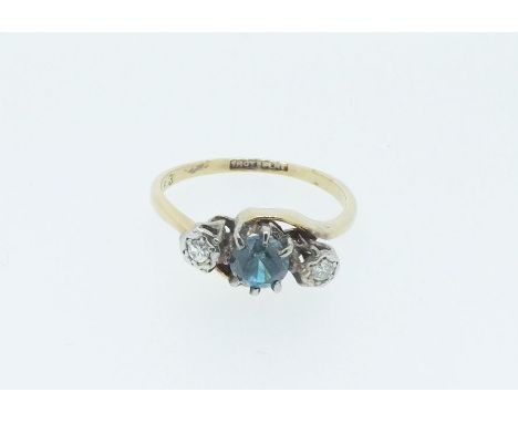 An 18 carat gold and platinum ring set blue zircon flanked by two singe cut diamonds, size L/M 