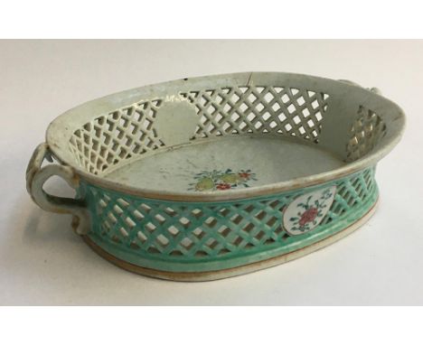 An 18th century continental ceramic basket, with pierced sides and floral spray decoration, heightened in gilt, 39cmD 