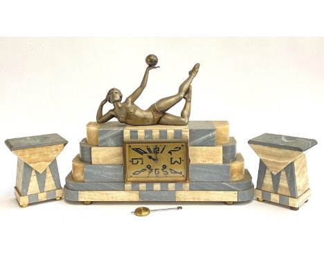 A marble Art Deco French mantel clock, including key pendulum and two garnitures, appears to be in working order as of the ti