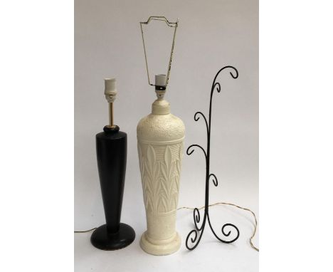 A turned ebonised wood table lamp; together with one other and a wrought iron stand 