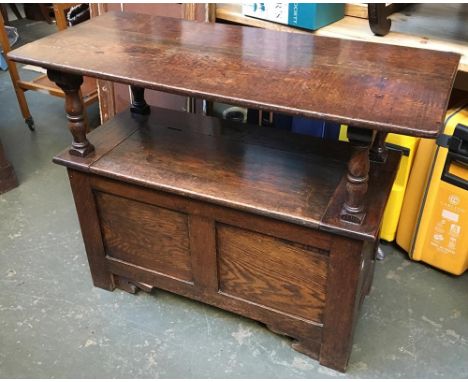 An early 20th century oak settle/monk's bench, with metamorphic top, and hinged seat, 107x45x80cmH 