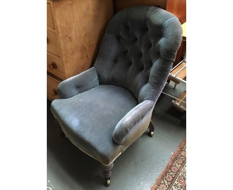 A button back nursing chair on turned legs and casters 