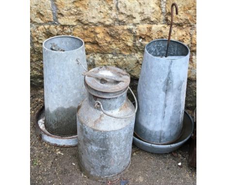 A vintage milk churn, 54cmH; together with two poultry feeders 