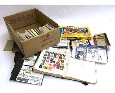 A small collection of stamps, postcards and cigarette cards, with first day covers and albums 
