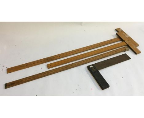 Two vintage architect squares, together with a yard stick and a wooden brass set square 