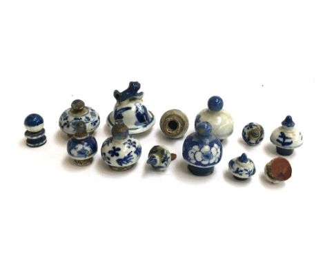 A small collection of 12 Oriental blue and white ceramic lids and stoppers 